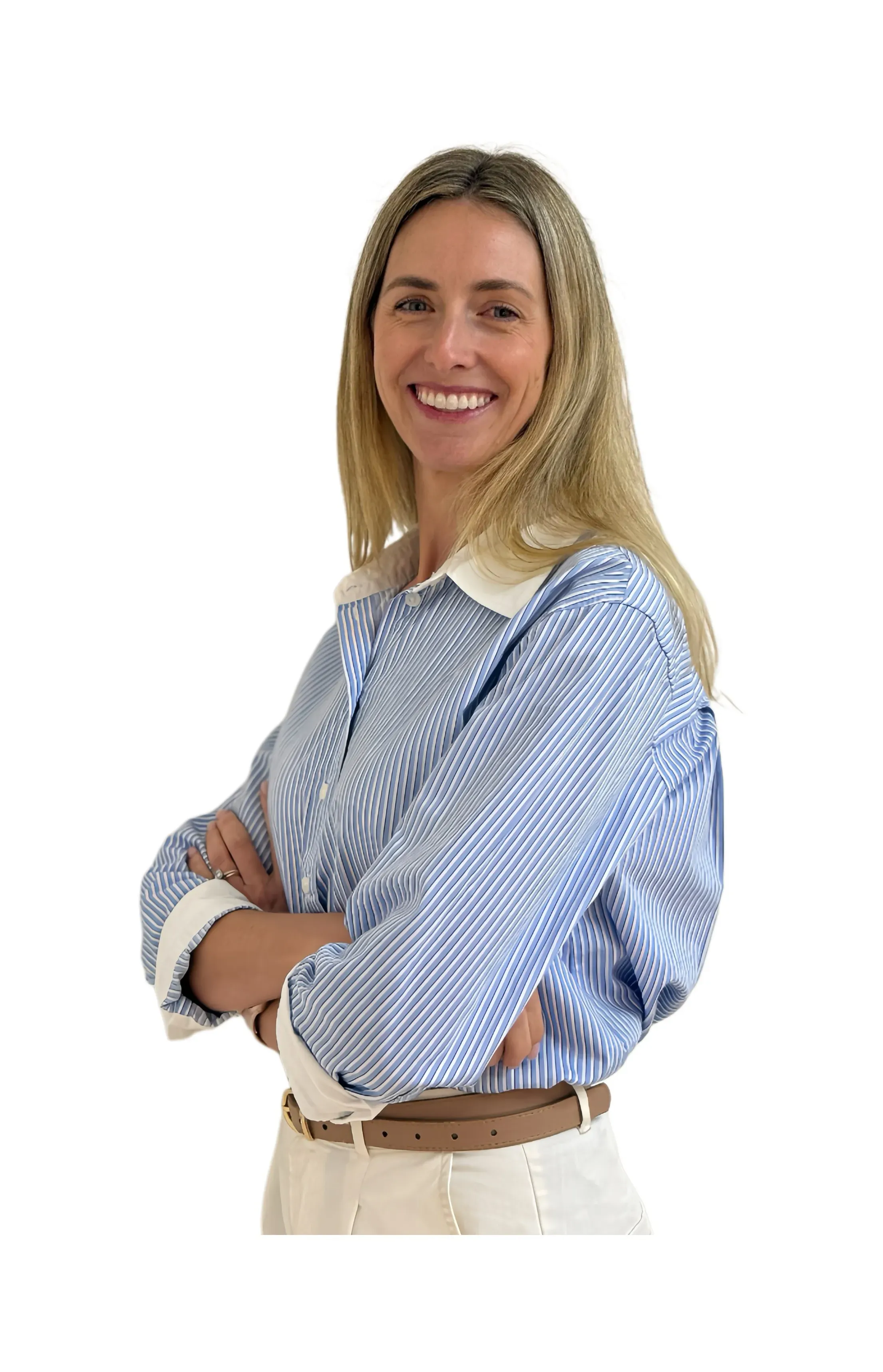 IMG_3957 2 - Perfect Balance Rehabilitation Centre Smiling woman with blonde hair, wearing a blue striped button-down shirt and tan belt, arms crossed in front of a white background.